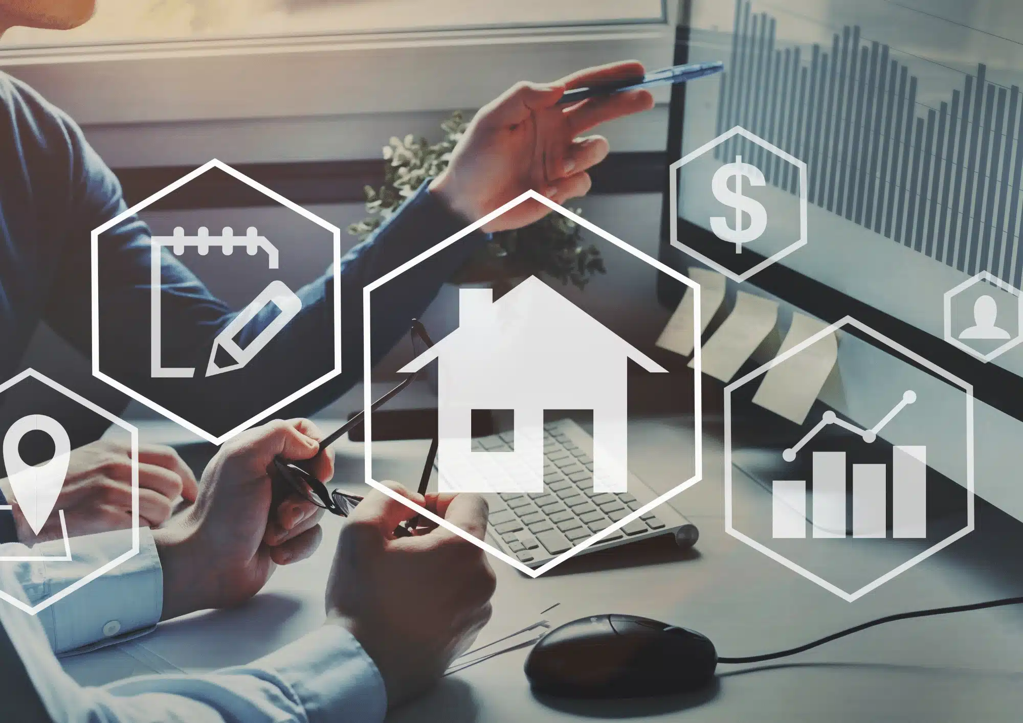 Dos personas están sentadas frente a una pantalla de computadora que muestra gráficos de crecimiento, mientras discuten sobre marketing inmobiliario. Varias figuras holográficas hexagonales superpuestas con iconos como una casa, un mapa y un signo de dólar flotan en el aire.
